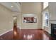 Bright living room with view into the kitchen, hardwood floors, and natural light at 6806 Powder Dr, Indianapolis, IN 46259