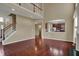 Open living room with hardwood floors, a staircase, and view into the kitchen at 6806 Powder Dr, Indianapolis, IN 46259
