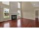 Spacious living room with fireplace, large windows, and hardwood flooring at 6806 Powder Dr, Indianapolis, IN 46259
