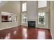 Bright living room featuring a fireplace, windows, and view into the kitchen at 6806 Powder Dr, Indianapolis, IN 46259