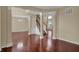 Bright living area with hardwood floors, view of stairway, and open layout at 6806 Powder Dr, Indianapolis, IN 46259