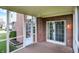 View of the screened porch with brick siding, wood floor, and door leading to the backyard at 6806 Powder Dr, Indianapolis, IN 46259
