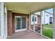 Relaxing screened porch with wood flooring and brick siding offers outdoor living space at 6806 Powder Dr, Indianapolis, IN 46259