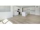 Open-concept living and kitchen area with modern appliances, sleek cabinetry, and wood-style flooring at 6848 Jacone Dr, Brownsburg, IN 46112
