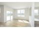 Bright living room with sliding glass door and large windows showcasing backyard views and natural light at 6848 Jacone Dr, Brownsburg, IN 46112