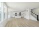 Expansive open floorplan: living area with staircase flowing into modern kitchen, all well-lit at 6848 Jacone Dr, Brownsburg, IN 46112