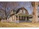 Charming brown two-story home with a cozy front porch and well-maintained yard at 706 N Euclid Ave, Indianapolis, IN 46201