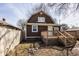 Charming home featuring a wooden deck, stairs, and cozy backyard with fire pit bricks at 706 N Euclid Ave, Indianapolis, IN 46201