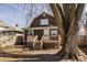 Home exterior featuring a wood deck with stairs and a large tree in the yard at 706 N Euclid Ave, Indianapolis, IN 46201