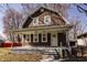 Charming brown two-story home with a cozy front porch and well-maintained yard at 706 N Euclid Ave, Indianapolis, IN 46201
