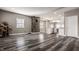 Open-concept living space with modern flooring, a stone fireplace, and a seamless transition to the kitchen at 706 N Euclid Ave, Indianapolis, IN 46201