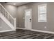 Bright living room featuring hardwood floors, fresh paint, and abundant natural light through a window at 706 N Euclid Ave, Indianapolis, IN 46201