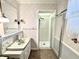 Vintage bathroom with a glass-enclosed shower and patterned wallpaper at 75 S 11Th Ave, Beech Grove, IN 46107
