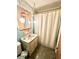 Vintage-style bathroom featuring patterned shower curtain and globe pendant lighting at 75 S 11Th Ave, Beech Grove, IN 46107
