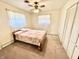 Cozy bedroom with natural light, complemented by a ceiling fan and convenient closet at 75 S 11Th Ave, Beech Grove, IN 46107