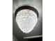 Close-up of a decorative chandelier with dangling crystals reflecting light at 75 S 11Th Ave, Beech Grove, IN 46107