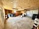Spacious garage with plywood walls, concrete flooring, overhead lighting and ample storage space at 75 S 11Th Ave, Beech Grove, IN 46107