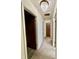 Hallway with carpet flooring, a decorative chandelier and several paneled doors to adjacent rooms at 75 S 11Th Ave, Beech Grove, IN 46107