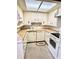 Compact kitchen with white appliances, wood countertops, and a skylight at 75 S 11Th Ave, Beech Grove, IN 46107