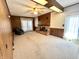 Bright living room with a brick fireplace, wood paneling, large sliding doors and neutral carpeting at 75 S 11Th Ave, Beech Grove, IN 46107