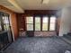 Enclosed sunroom featuring tile flooring, brick accents, multiple windows and a secure entry door at 75 S 11Th Ave, Beech Grove, IN 46107