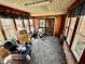 Relaxing sunroom with tile flooring, brick accents, comfortable seating and natural light at 75 S 11Th Ave, Beech Grove, IN 46107