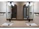Bathroom features a double sink vanity with modern black fixtures and lighting, enhancing its style at 7837 Hunters Path, Indianapolis, IN 46214
