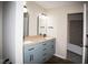 Modern bathroom boasts a double sink vanity with sleek, dark hardware and a view of the closet at 7837 Hunters Path, Indianapolis, IN 46214