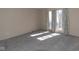 Sunlit bedroom featuring neutral walls and carpet flooring creates a bright and inviting space with windows at 7837 Hunters Path, Indianapolis, IN 46214