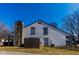 Exterior of home with stone chimney and siding, fenced in yard at 7837 Hunters Path, Indianapolis, IN 46214