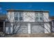 Two-story home featuring a garage, white siding, and double-paned windows at 7837 Hunters Path, Indianapolis, IN 46214