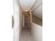 Neutral hallway, carpeted, and illuminated by recessed lighting, provides access to rooms with white doors at 7837 Hunters Path, Indianapolis, IN 46214