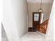 View of the staircase and front door with glass inserts at 7837 Hunters Path, Indianapolis, IN 46214