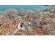 Scenic aerial view of a lakeside home nestled among trees, offering privacy and natural beauty at 7899 S Timber Cliff Ln, Trafalgar, IN 46181