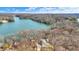 Breathtaking aerial view showcasing a lake house surrounded by lush woodland and calm waters at 7899 S Timber Cliff Ln, Trafalgar, IN 46181