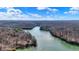 Aerial view showcases a winding river surrounded by dense forests and nature at 7899 S Timber Cliff Ln, Trafalgar, IN 46181