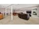 Open basement with a pool table, media area, and neutral carpeting at 7899 S Timber Cliff Ln, Trafalgar, IN 46181