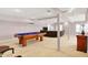 Finished basement with a pool table, neutral carpet, ample lighting, and comfortable leather sofa at 7899 S Timber Cliff Ln, Trafalgar, IN 46181