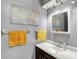 Bathroom with a dark wood vanity, mirror, and gray walls with a framed abstract art piece at 7899 S Timber Cliff Ln, Trafalgar, IN 46181