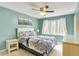 Comfortable bedroom featuring seafoam green walls, ceiling fan, and natural light from a window at 7899 S Timber Cliff Ln, Trafalgar, IN 46181