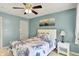 Comfortable bedroom featuring seafoam green walls, ceiling fan, and natural light from a window at 7899 S Timber Cliff Ln, Trafalgar, IN 46181