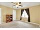 Bedroom featuring tan walls, plush carpeting, and natural light from a window at 7899 S Timber Cliff Ln, Trafalgar, IN 46181