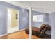 Bonus room with wood floors, neutral walls, and comfortable chaise lounge at 7899 S Timber Cliff Ln, Trafalgar, IN 46181