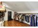 Spacious walk-in closet with hardwood floors, clothing racks, and secure gun safe at 7899 S Timber Cliff Ln, Trafalgar, IN 46181
