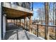 Lower deck with a view of the lake and houses, featuring modern railings and gray wood at 7899 S Timber Cliff Ln, Trafalgar, IN 46181