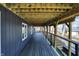 Outdoor deck with wooden plank flooring and ceiling offers a view of the beautiful lake and surrounding trees at 7899 S Timber Cliff Ln, Trafalgar, IN 46181