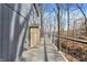 Lake house deck with neutral gray planks and black metal railing overlooks a wooded view at 7899 S Timber Cliff Ln, Trafalgar, IN 46181