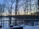 Snowy deck view of the lake through the trees, capturing a serene winter scene at 7899 S Timber Cliff Ln, Trafalgar, IN 46181