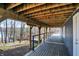 Spacious outdoor deck featuring plank flooring and wooden ceiling offers amazing lake views at 7899 S Timber Cliff Ln, Trafalgar, IN 46181