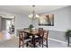 Cozy dining room featuring a square table, four chairs, and a decorative chandelier at 7899 S Timber Cliff Ln, Trafalgar, IN 46181